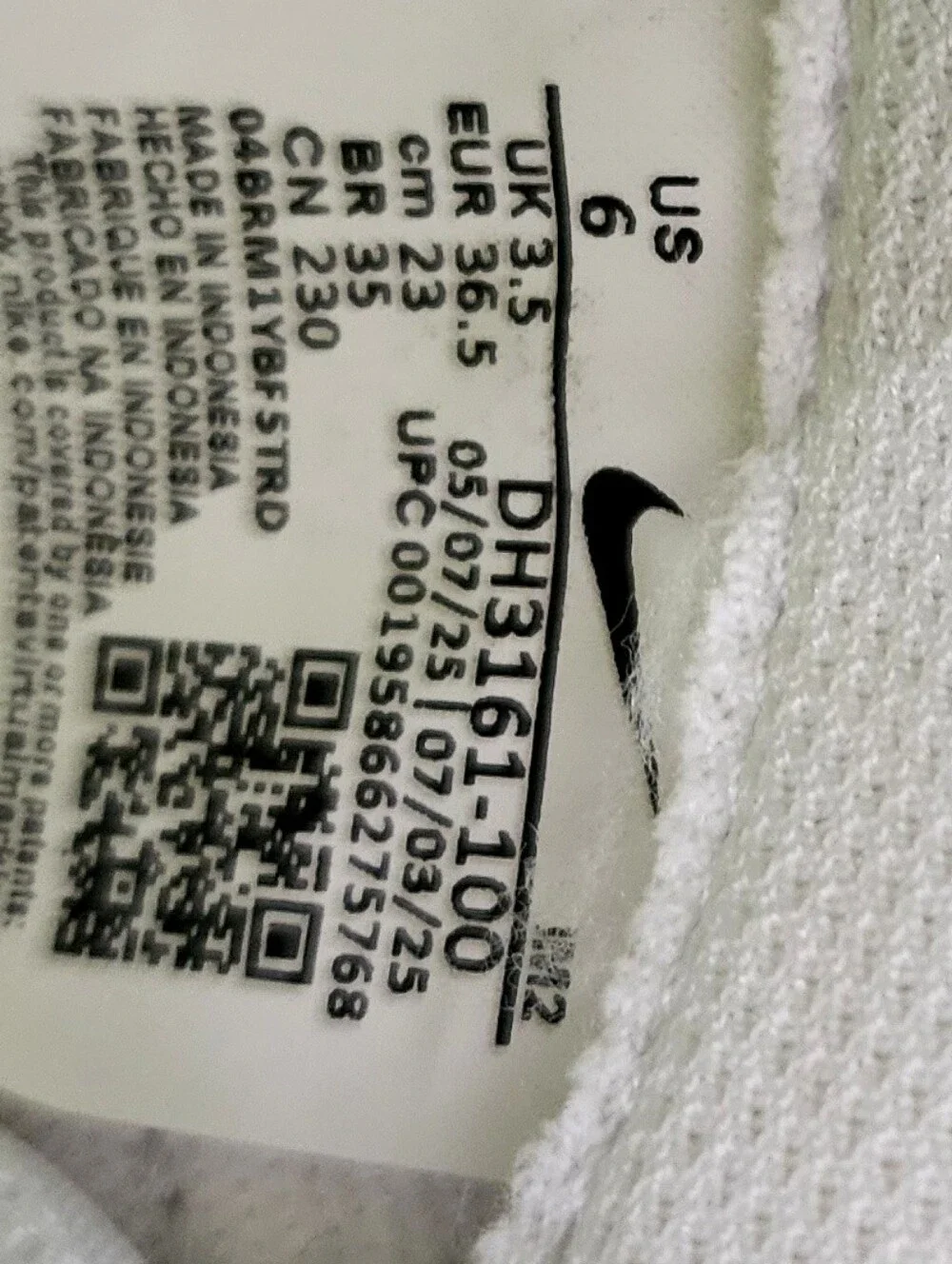 Nike White Low-Top Sneakers with Black Swoosh and Mustard Stripe